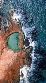 High angle view of rock formation in sea