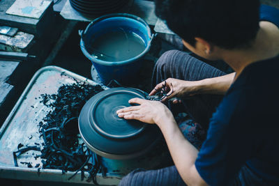 High angle view of man working in kitchen