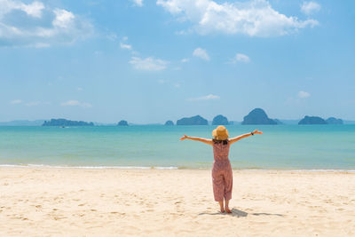 Rear view of woman walking on beach