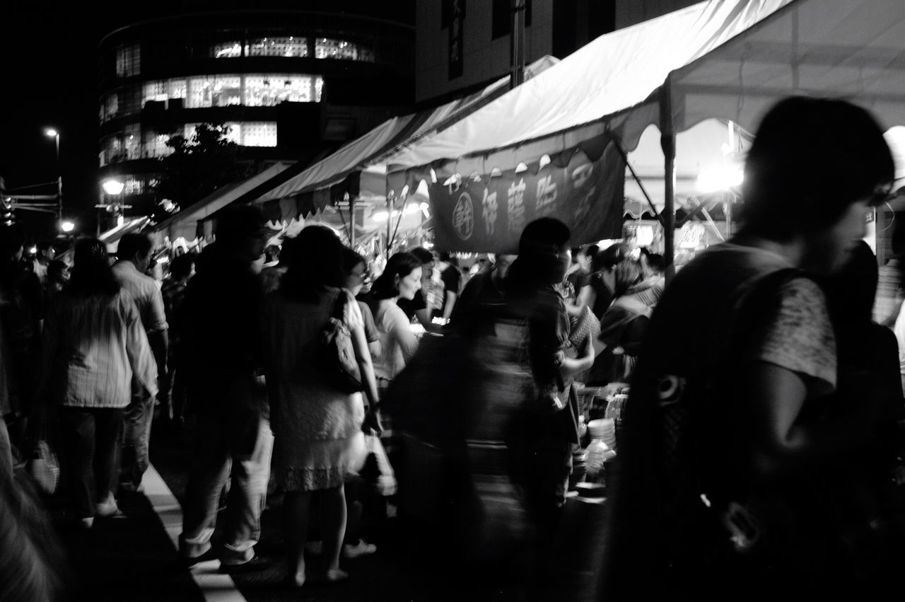 PEOPLE WALKING ON STREET IN CITY