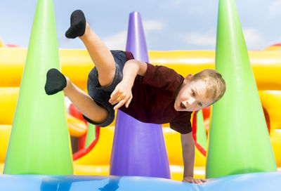 Boy jumping on bouncy castle