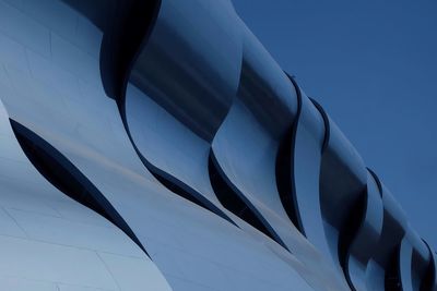 Low angle view of modern building against blue sky