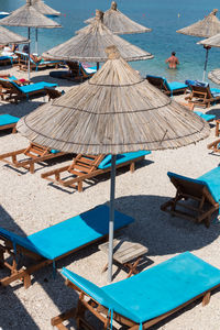 High angle view of deck chairs on beach