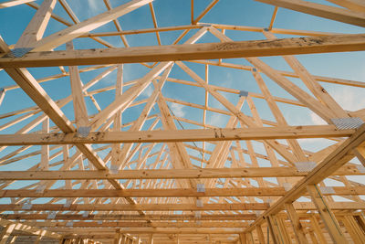 Low angle view of metallic structure against blue sky