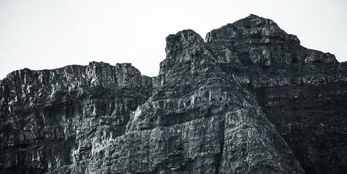 Low angle view of rock formation against clear sky