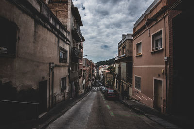 Street amidst buildings against sky in city