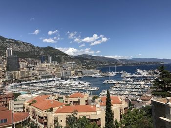 High angle view of townscape by sea against sky