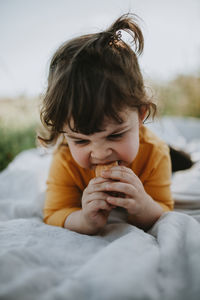 Portrait of boy looking away while sitting outdoors