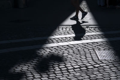 Low section of woman walking on street