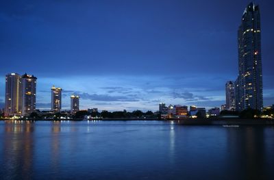 Illuminated city at waterfront