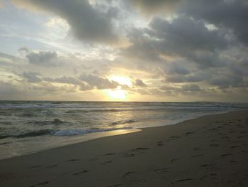 Scenic view of beach against sky during sunset