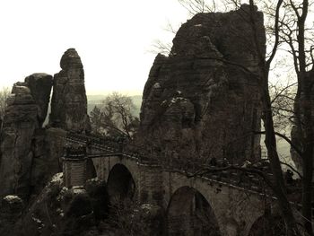 Low angle view of old ruin bridge against sky