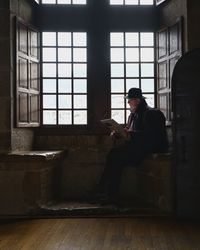 Man sitting on open window