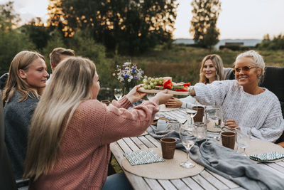 Friends having meal in garden