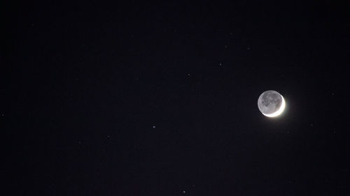 Low angle view of moon against clear sky at night