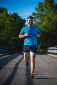 Young man jogging on road