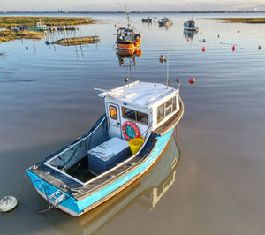 High angle view of fishing boats moored in lake