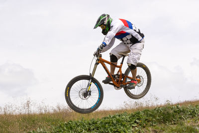 Man riding bicycle on grassland