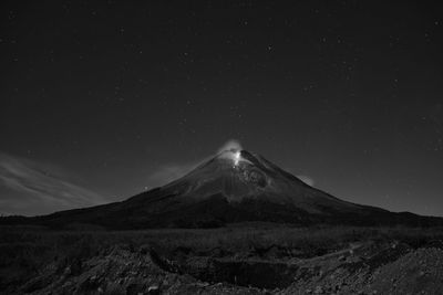 Scenic view of mountains against sky at night