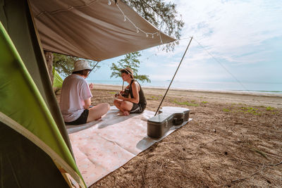 Asian musician couple playing guitar with happiness and joyful from honeymoon activity in summer