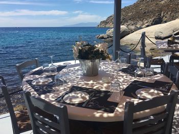 Place setting at table by sea