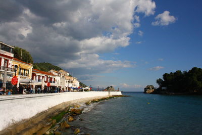 Scenic view of sea and buildings against sky