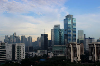 View of skyscrapers against cloudy sky