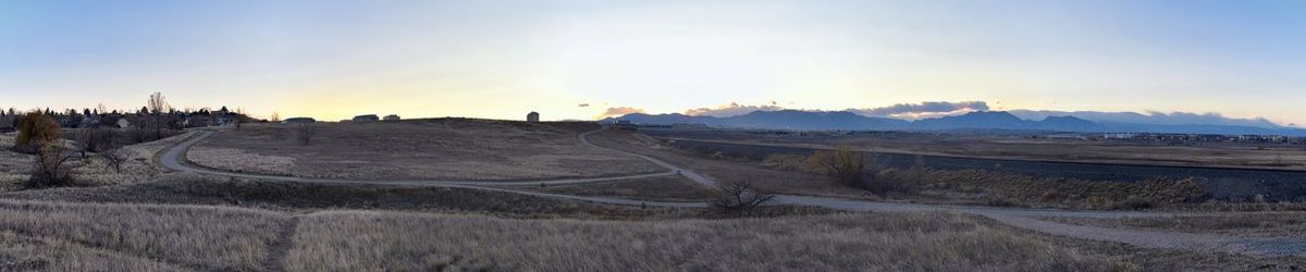 Panoramic shot of land road against sky during sunset