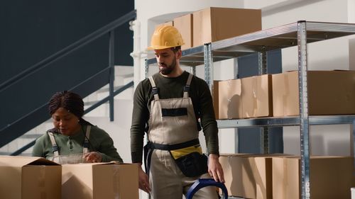 Portrait of young man standing in factory