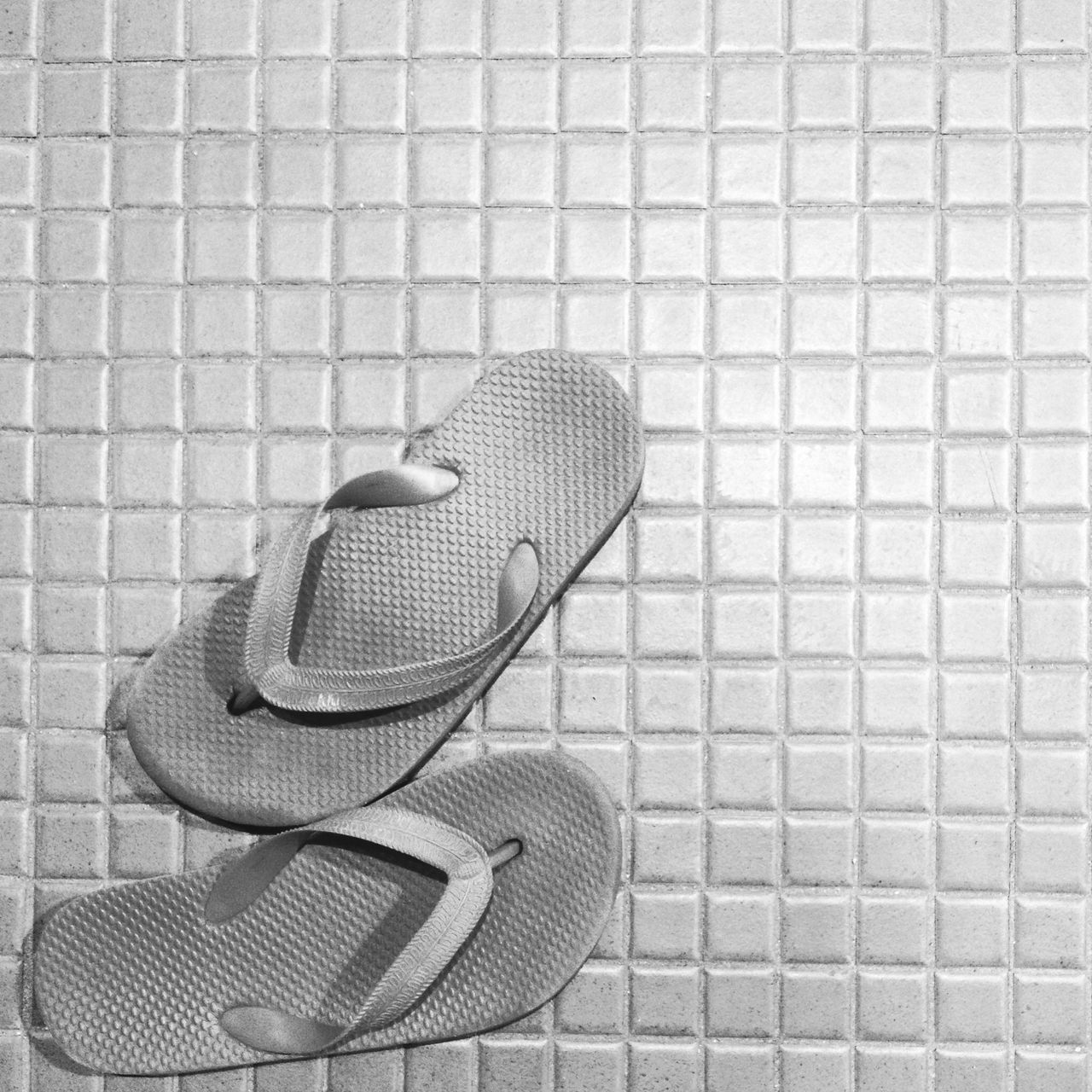 high angle view, shoe, chair, still life, tiled floor, absence, footwear, shadow, cobblestone, wall - building feature, flooring, sidewalk, metal, brick wall, day, pattern, empty, seat, tile, indoors