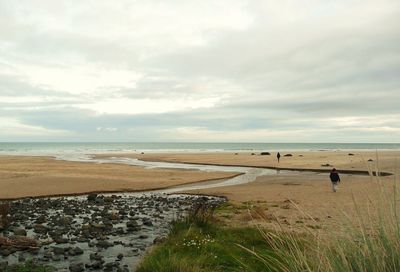 Scenic view of sea against cloudy sky