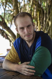 Portrait of young man against plants