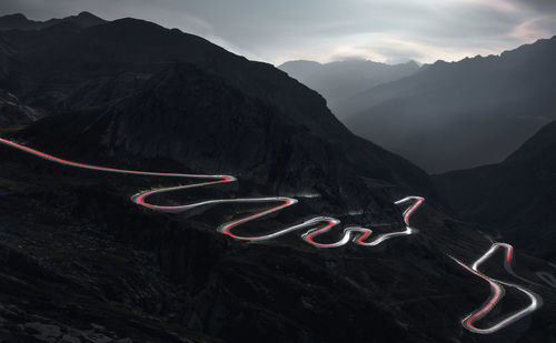 Aerial view of illuminated mountains against sky at night