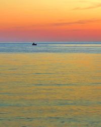 Scenic view of sea against orange sky