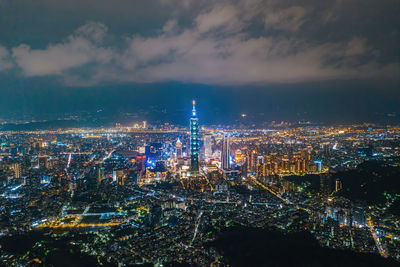 Illuminated cityscape against sky at night