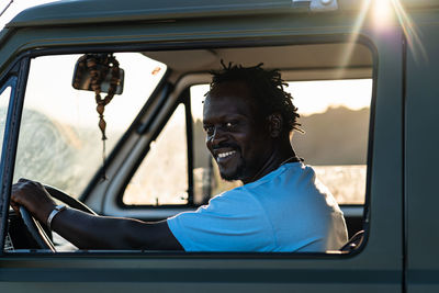 Portrait of smiling afro american man driving