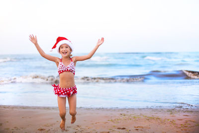 Full length of woman standing on beach