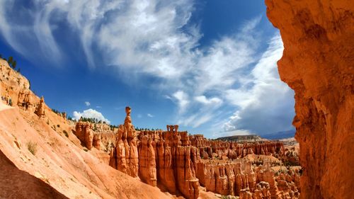 Scenic view of mountains against cloudy sky