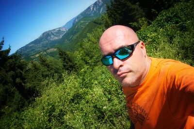 Portrait of man wearing sunglasses on mountain