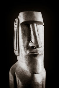 Close-up portrait of man against black background