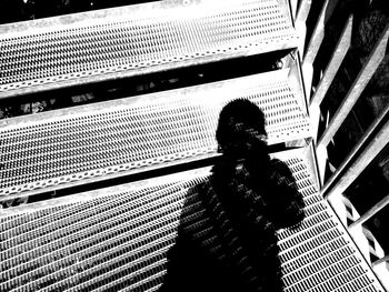 High angle view of man and woman standing on escalator