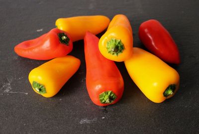 High angle view of orange and red bell peppers on table