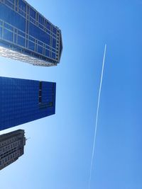 Low angle view of vapor trails in sky