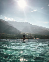 Man in swimming pool against sky