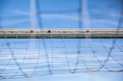 Low angle view of net against blue sky