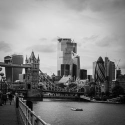 Bridge over river with buildings in background