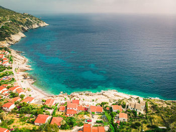High angle view of townscape by sea against sky