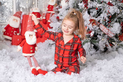 Cute bay girl sitting on fake snow at home