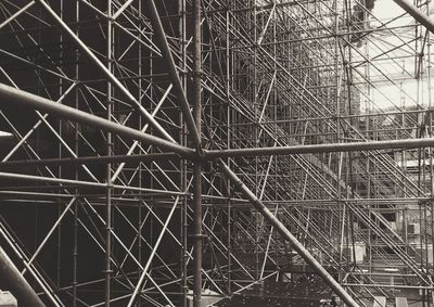 Backstage shot at a stadium concert showing the scaffolding needed to support the screens