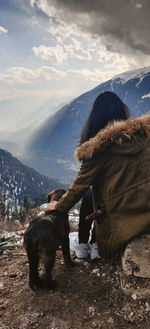 Dog on field against sky